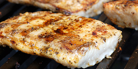 mahi steaks sizzling on a grill